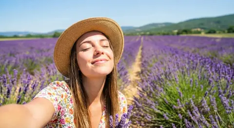 After: the same lavender field selfie with only the woman in the sun hat