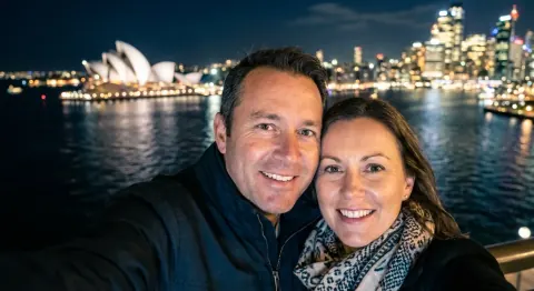 Before: a couple’s night selfie by Sydney Harbour with the Opera House behind them