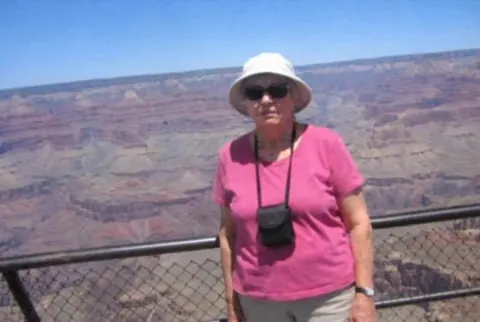 After: the same canyon photo with only the woman in the pink shirt