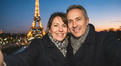 Before: a couple’s selfie in front of the Eiffel Tower at dusk