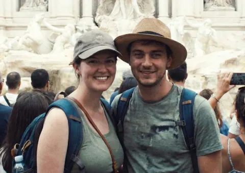 Before: a couple’s selfie in a crowd in front of a fountain with marble statues